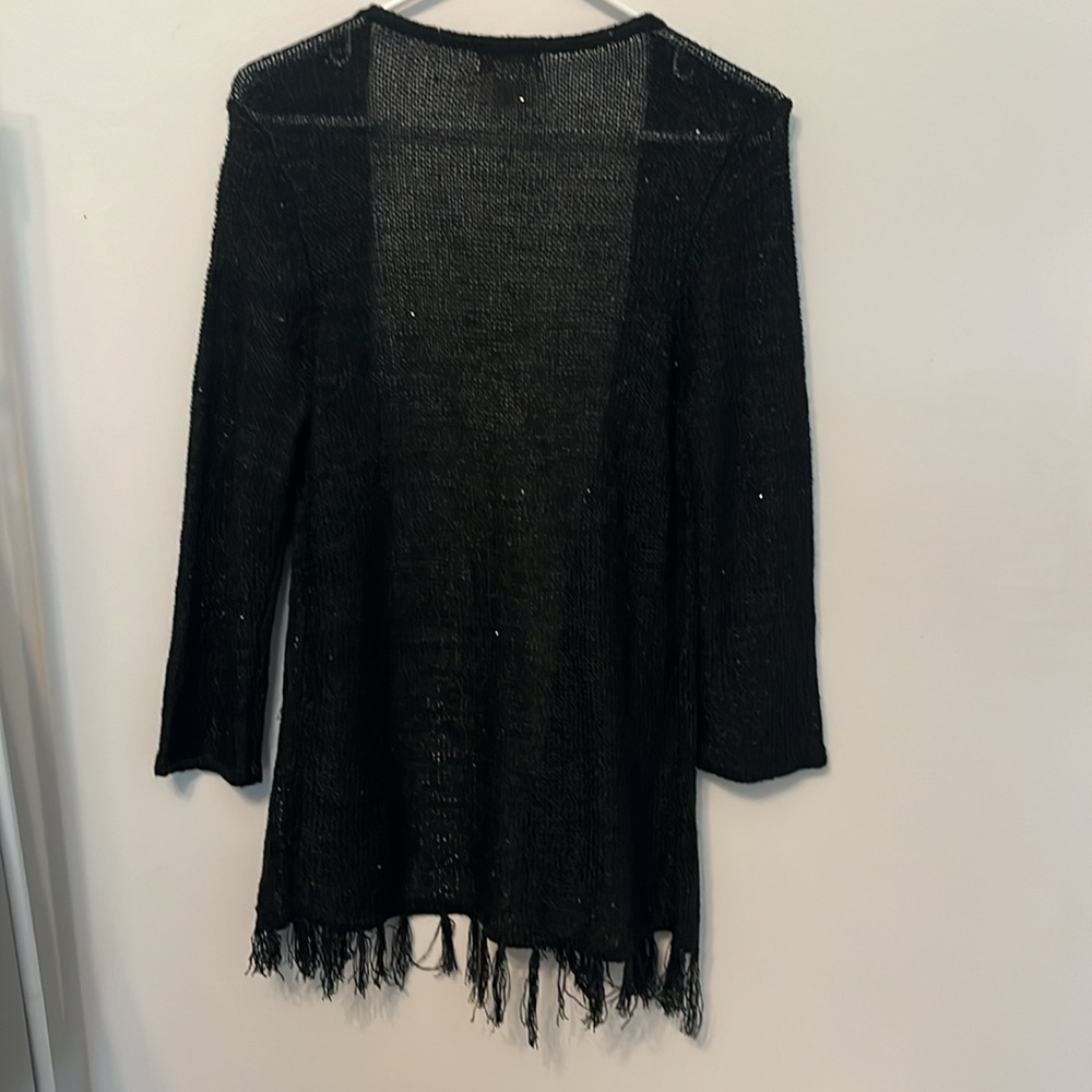 Black open top with a hint of sparkles and fringe bottom.
